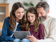 © jes2uphoto - Happy family of three sitting closely together watching content on tablet, sharing joyful moment in cozy home environment