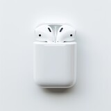 White wireless earbuds in charging case, top view