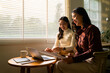 © PaeGAG - Two Asian businesswomen discussing and working together with laptop and documents in office