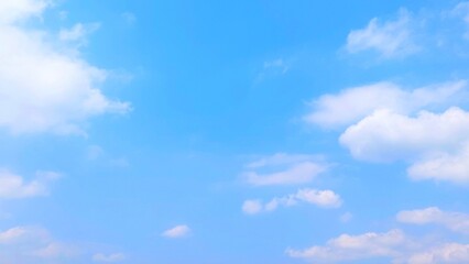 Wall Mural - Clear blue sky and fluffy white clouds. Nature sky with soft clouds focus effect, peaceful nature background.