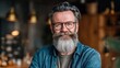 © Johannes - smiling relaxed mature older bearded hipster man looking at camera happy handsome confident middle aged 50s male professional standing at home office posing indoors for close up headshot portrait no
