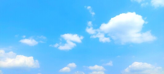 Wall Mural - Clear blue sky and fluffy white clouds. Nature sky with soft clouds focus effect, peaceful nature background.