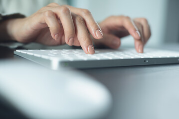 Wall Mural - closeup, business woman hand typing on desktop computer keyboard, online working, searching the info
