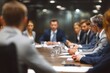 © Iftikhar alam - Business professionals engage in strategy discussion around a wooden conference table in a modern office setting during a corporate meeting
