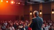 © king - A speaker on stage under a warm spotlight, engaging an unseen audience in a conference atmosphere.