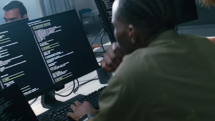 Professional Male Software developer, Computer Programmer typing on laptop keyboard working on code, ai prompt, software development application in office. Coding and artificial intelligence.