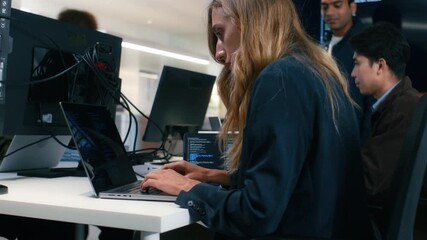 Professional Female Cyber Security, Computer Programmer typing on laptop keyboard working on code, ai prompt, software development application in office. Coding and artificial intelligence.
