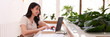 © snowing12 - Asian adult woman freelance business entrepreneur works remote modern cafe using laptop computer for flexible online career lifestyle happy expression