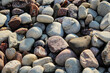 © Caroline - Closeup of river rock, a natural stone product commonly used in landscaping and outdoor design.  Background with copy space