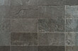 © Alex - Dark grey slate tiles background, natural stone texture.