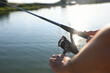 © New Africa - Fisherman with rod fishing near lake at summer, closeup