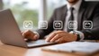 © somchairakin - Businessman using laptop with digital icons representing document management. scene conveys efficiency and modern technology