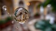 © BOJOShop - Close up of a clear water droplet suspended mid air filled with tiny air bubbles