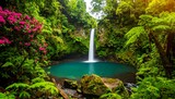 Lush rainforest waterfall cascades into a vibrant teal pool, surrounded by vibrant greenery and pink flowers