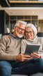 © ธวัชชัย นพพิบูลย์ - Elderly couple using a tablet together on sofa, bright modern home, professional compos