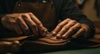 © CrazyJuke - Artisan's Touch: A skilled artisan meticulously works on a piece of premium leather, focused and dedicated to the craft.