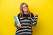 © luismolinero - Young student woman isolated on yellow background background pointing up a great idea