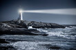 © Cavan Images - Peggy’s Cove lighthouse beam over rough ocean waters in Nova Scotia