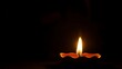 © aliececome - Golden diya glowing in darkness, symbolizing tradition and festive spirit in Indian culture.