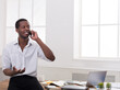 © Prostock-studio - Business call. Young african-american businessman in white has mobile phone talk in modern white office interior.