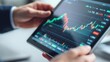 © mamoo studio - Monitoring market trends on a tablet