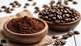 Wooden bowls filled with ground coffee and coffee beans set against a white background