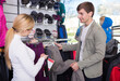 © caftor - Man shopping for hiking pants with female assistant