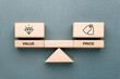 © patpitchaya - Wooden blocks on balance scale showing value and price icons, concept of cost, worth, business decision, financial strategy, customer perception