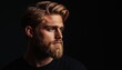 © Tetiana - Stylish Young Caucasian Man With Beard And Handsome Hairstyle Poses Dramatically In Studio With Black Background And Free Copy Space.