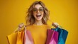 © sarayut - Happy Young Woman with Colorful Shopping Bags Against Yellow Background