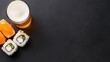 © Pica Be - Sushi rolls and a glass of beer on a dark background