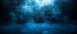 © Pixels Stock - Ethereal blue light streams down from above illuminating swirling mist and a wet reflective surface in a dark atmospheric environment