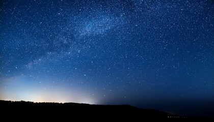 Wall Mural - a stunning night sky filled with bright twinkling stars against a dark blue background creating a serene and peaceful atmosphere