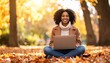 © meka - Smiling Woman Working Outdoors with Laptop amid Autumn Foliage in Golden Light