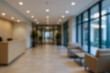© ATRPhoto - blurred for background. office building interior, empty hall in the modern office building. empty open space office. panoramic windows and beautiful lighting. Corporate Workspace,  Business Interior