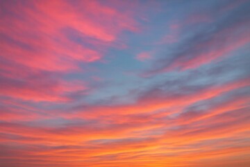 Wall Mural - a symphony of pink, blue, and orange hues in a cloudy sky