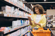 © anatoliycherkas - Woman Choosing Products in Supermarket Hygiene Aisle