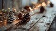 © Tatiana - rustic wooden surface with lit metallic garland, few pinecones, warm ambient light creating a festive and cozy atmosphere