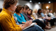 © Laura - Engaged Audience Taking Notes with Leaders in Background