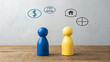 © Ramani - Financial and Legal Decision-Making Concept – Blue and Yellow Wooden Figurines with Speech Bubbles Showing Dollar Sign, Balance Scale, House, and Pie Chart Icons, Negotiation, Strategic Dialogue, Prop