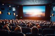 © Olla - Moviegoers fill a dark cinema, a large screen displays a film