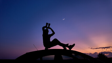 Wall Mural - man watching stars, milky way, planets, moon and other celestial objects from a car rooftop from a d