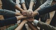 © PrabuanaAndika - Group of people putting their hands together in unity, teamwork, and support, emphasizing collaboration and community spirit