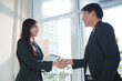 © crizzystudio - Businesspeople shaking hands after successful meeting in office