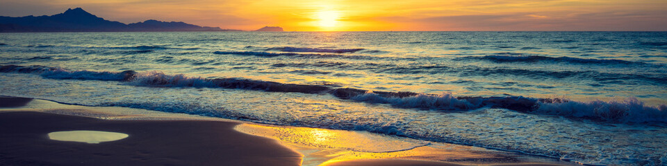 Wall Mural - Seascape in early morning during a beautiful purple sunrise. San Juan beach, Alicante, Spain, Europe