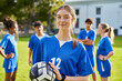 © Rido - Portrait of focused soccer female player holding football ball