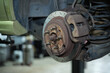 © Austockphoto - Car rotor with bolts, brake pad, and calipers