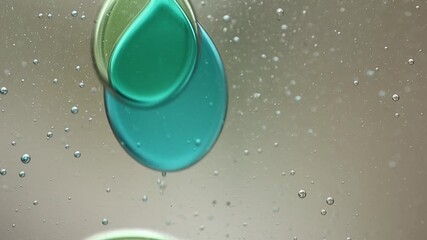 Wall Mural - Close-up of blue and green liquid with floating bubbles and blobs in motion inside a lava lamp, viewed in a horizontal orientation. Hypnotic and abstract visual texture.