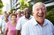 © Infographica Studio - x-default Happy Senior Citizens Walking Together Outdoors