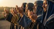 © Светлана Воротняк - Men in biblical attire praying with raised hands. Group of arabs in ancient robes during spiritual ritual at sunrise. Traditional worship for evangelical and religious concepts.